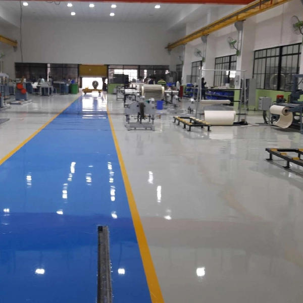 warehouse floor with a shiny, light gray epoxy coating and a marked blue walkway with yellow line